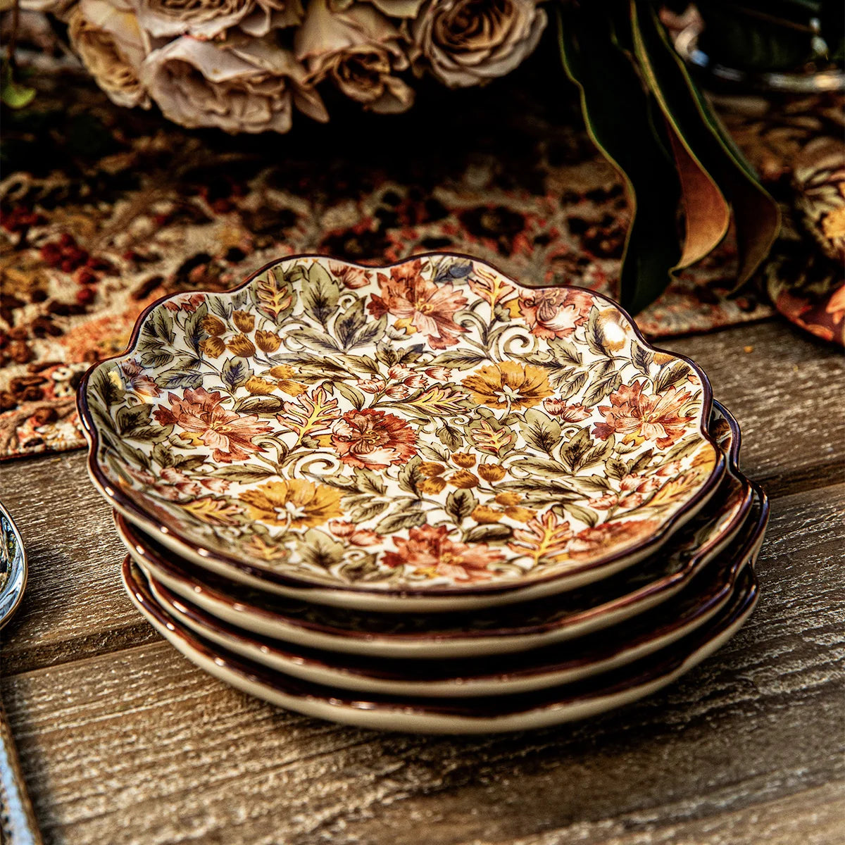 Stack of Juliska Willa scalloped cocktail plates on a rustic wooden table
