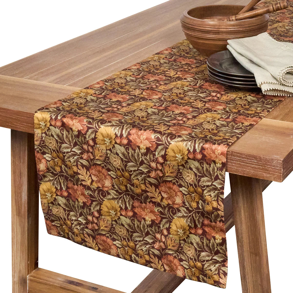 Juliska Willa table runner draped over a wooden table with a wood bowl and plates