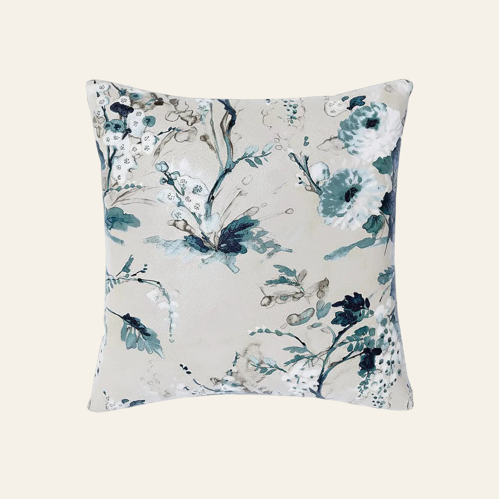 Ann Gish Jardin Fleur pillow in ivory with watercolor teal and navy floral print.