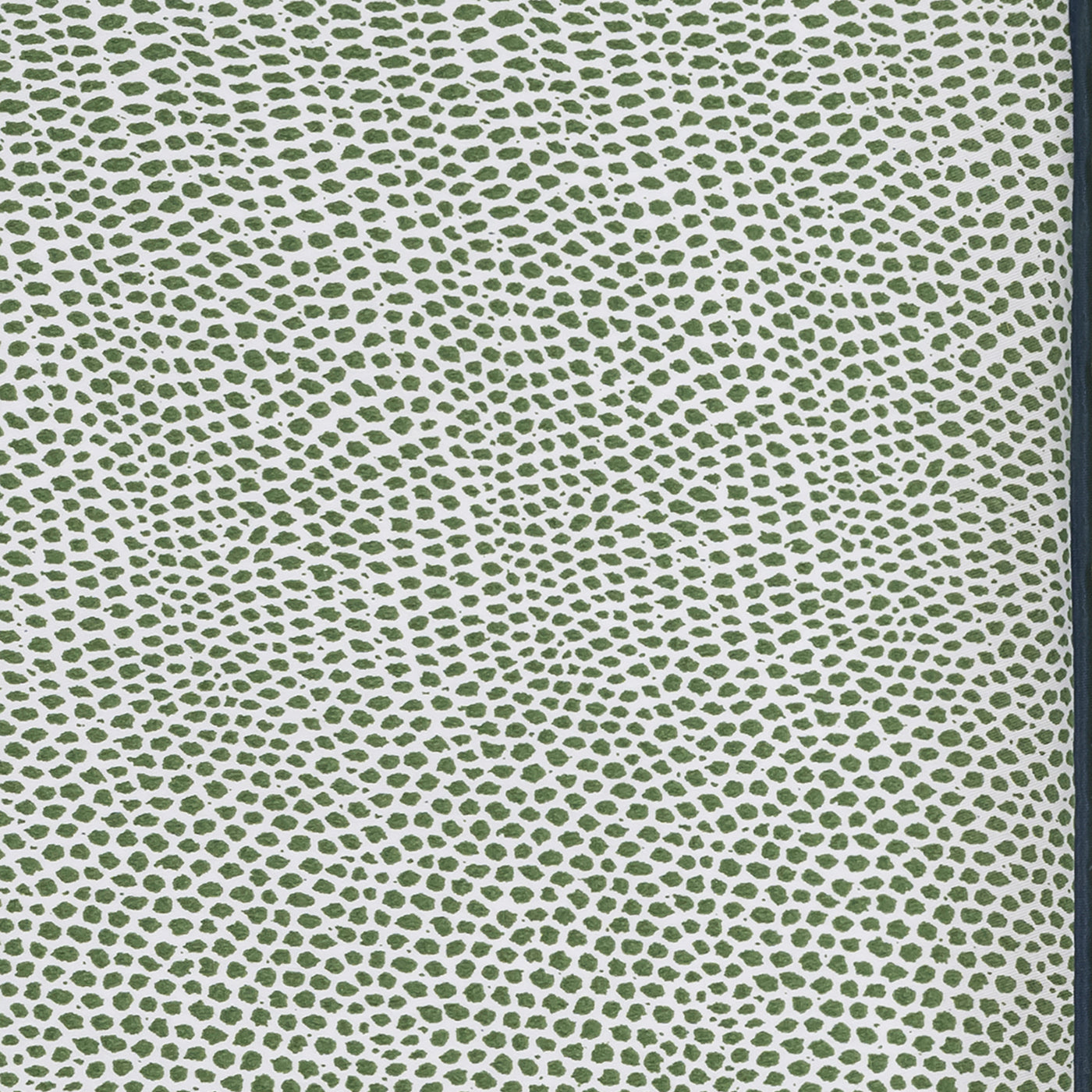 Close-up of Matouk Jasper sleep mask fabric in olive dotted pattern on ivory ground.