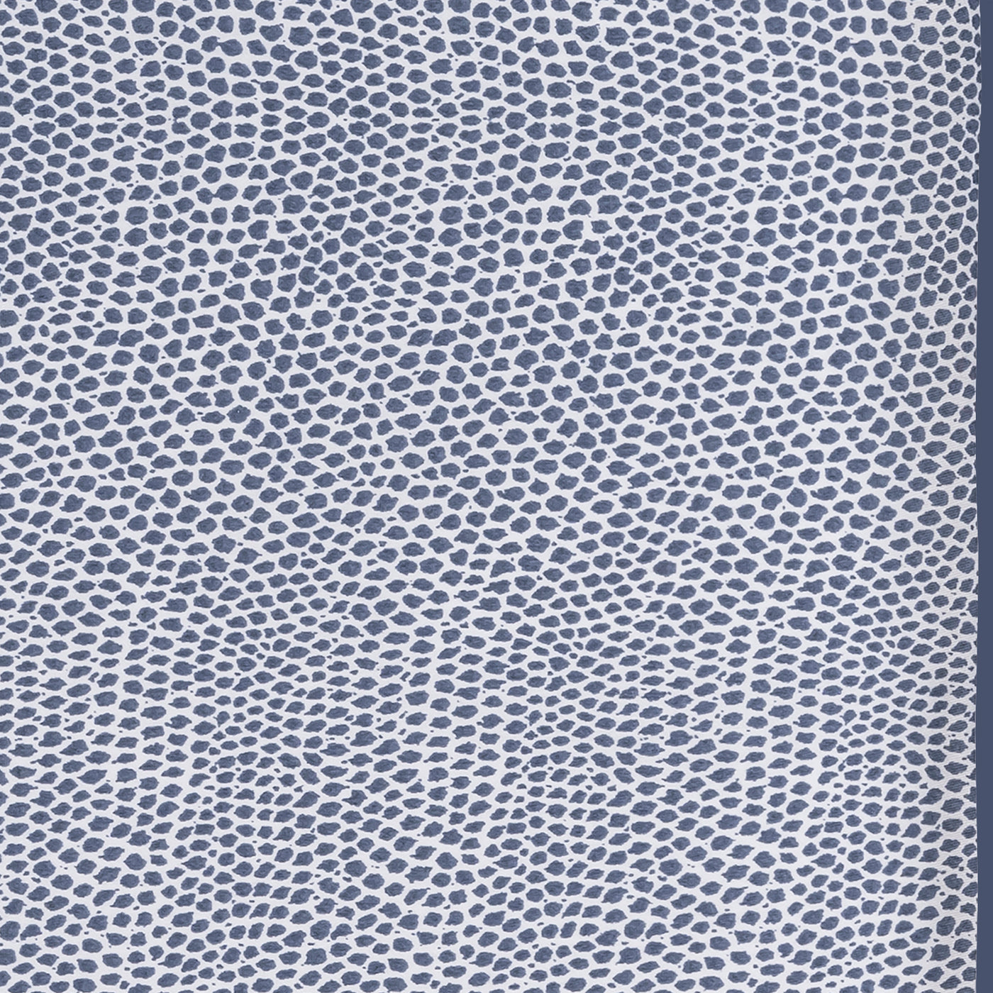 Close-up of navy and white dotted pattern on Jasper sleep mask fabric.