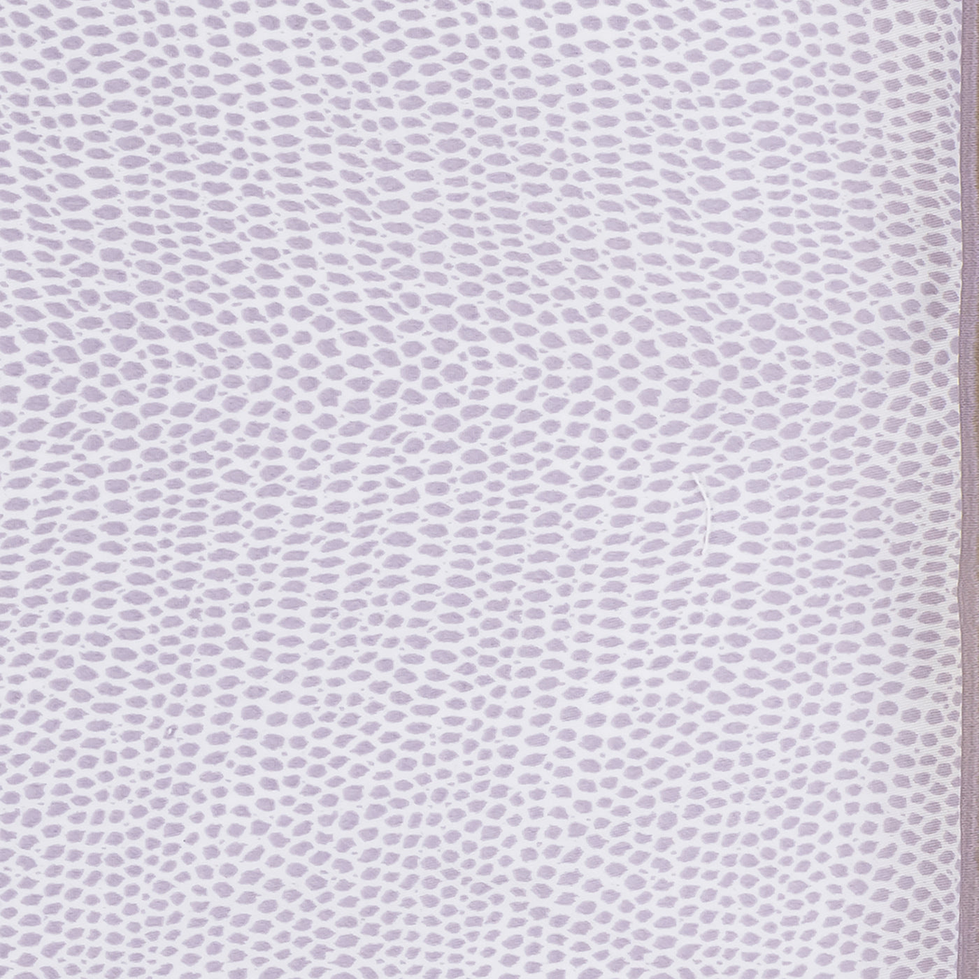 Close-up of Matouk Jasper sleep mask fabric in lavender scattered dot print.
