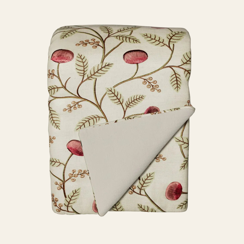 Ann Gish Joliet throw, ivory with red botanical floral embroidery, folded to show reverse.