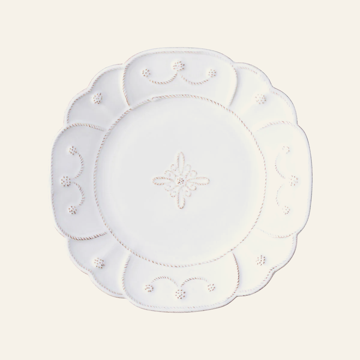 Juliska Jardins du Monde white ceramic salad plate with scalloped edge and floral motif.