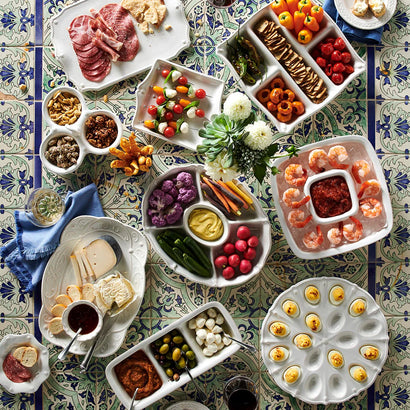 Overhead view of a festive tablescape with the egg platter styled among charcuterie and appetizer spreads.