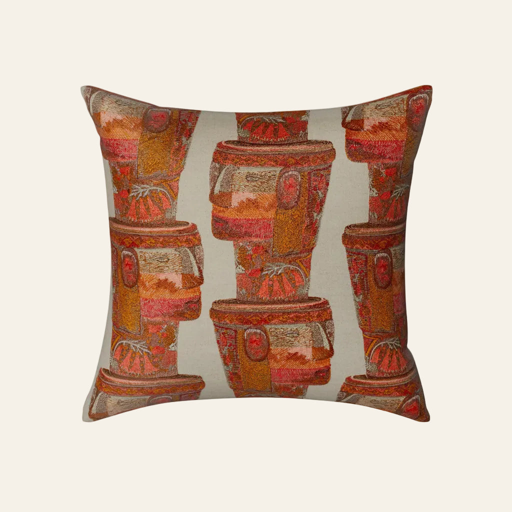 Ann Gish Kero pillow with terracotta pot print in warm red and amber tones on sage ground.