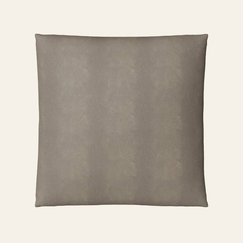 Ann Gish Komodo pillow in taupe with subtle reptile-texture pattern, square format.