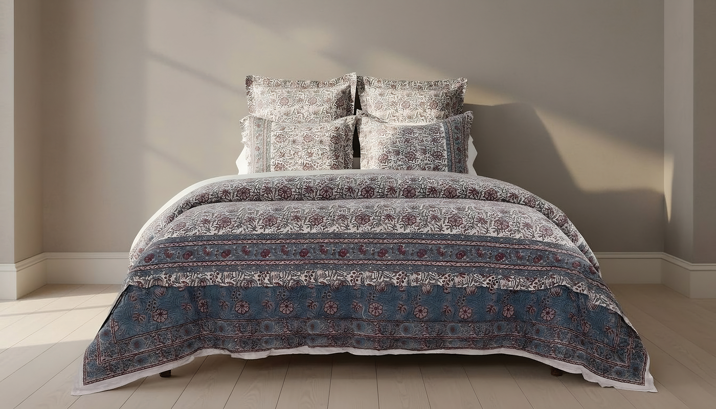 Full bed styled with Kyoto's navy and rust medallion-print bedding in a neutral room.