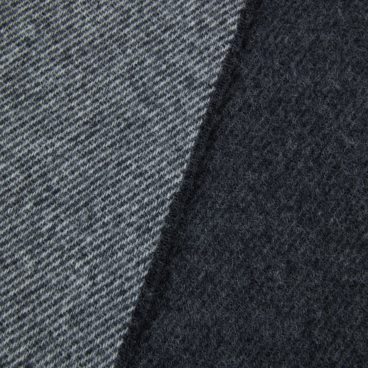 Close-up of Lanerossi Ascot throw showing contrast between twill weave face and brushed reverse in charcoal.