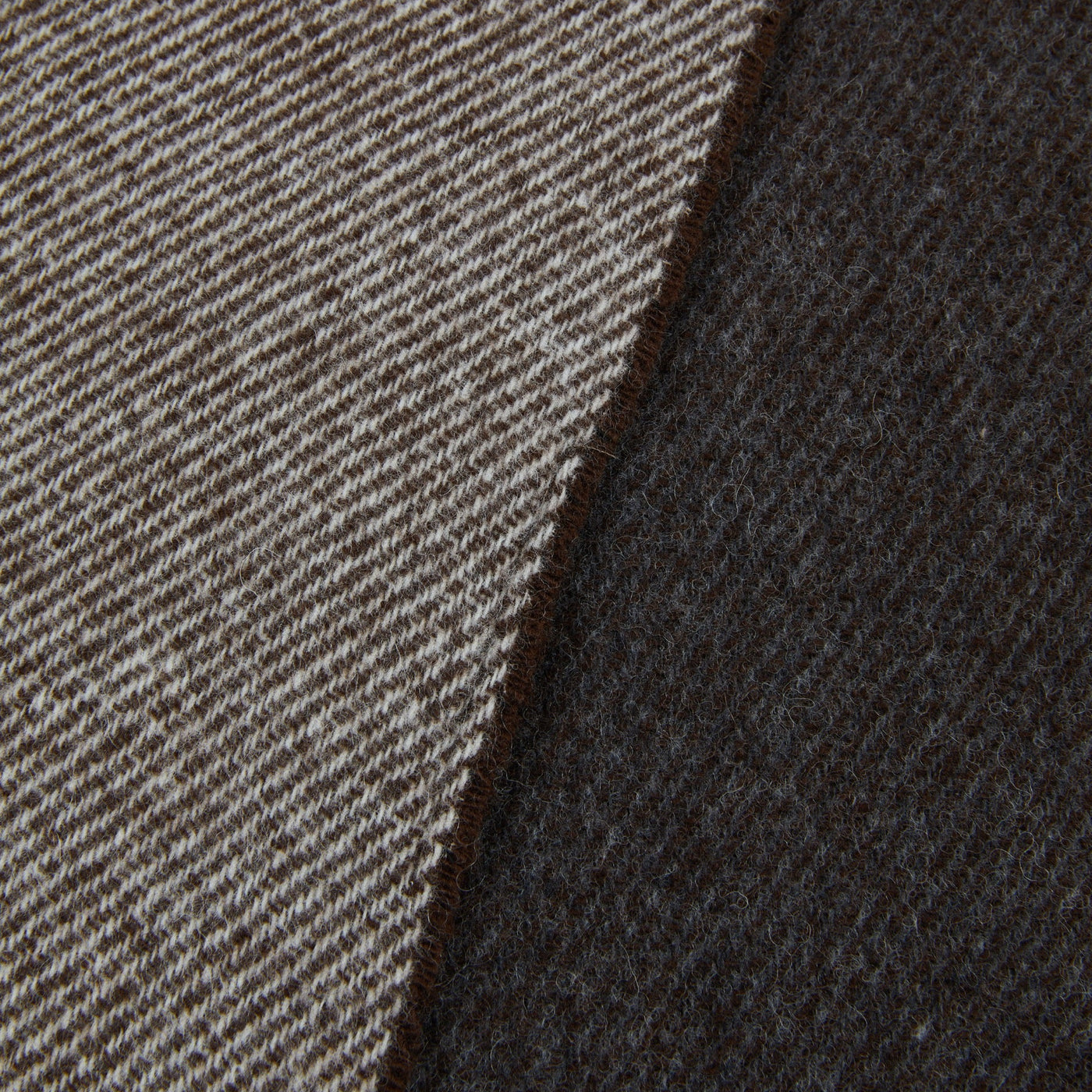 Close-up of Lanerossi Ascot throw showing reversible sides: taupe herringbone and dark espresso weave.