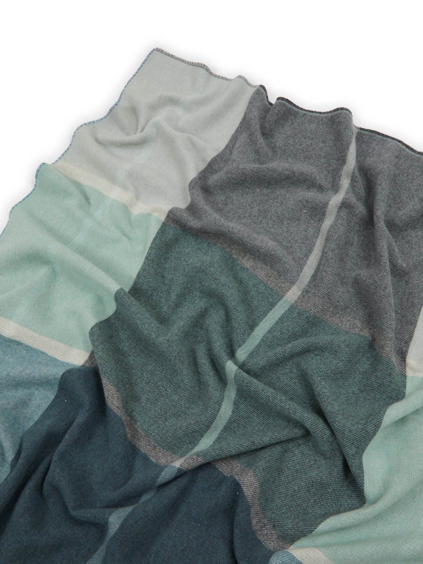 Close-up of Lanerossi Ascot throw draped loosely, showing teal, sage, and charcoal color-block panels.