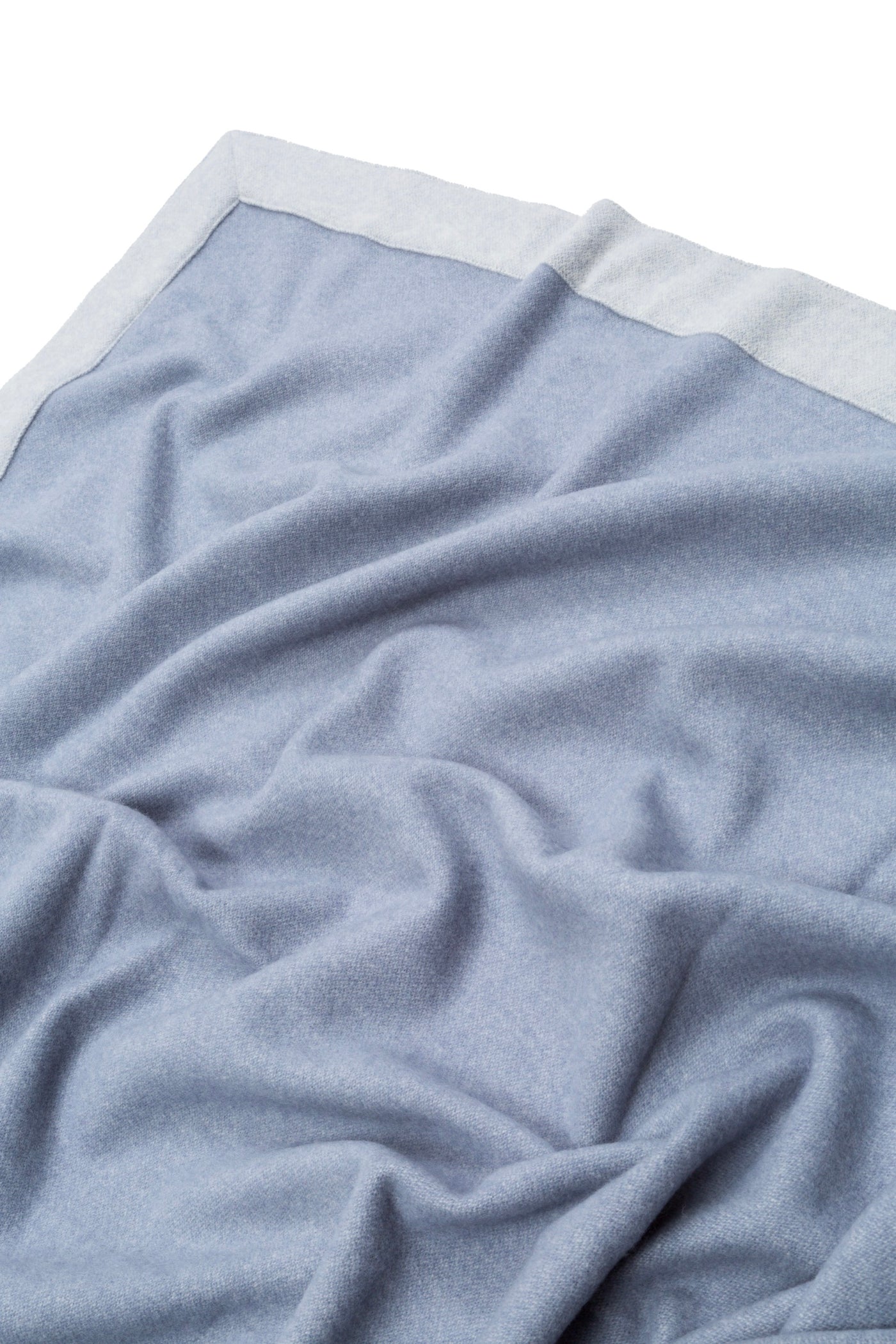 Lanerossi Afrodite blanket in powder blue with ivory border, softly draped close-up.