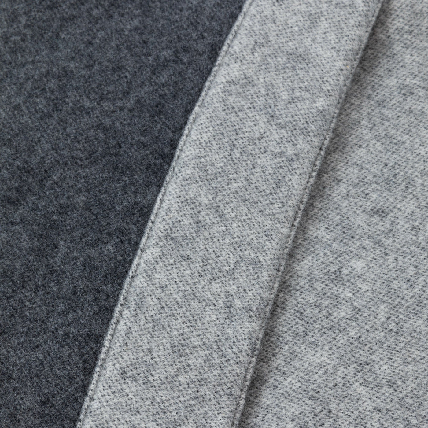 Close-up of charcoal and silver grey wool blanket panels showing felted texture and finished edges.