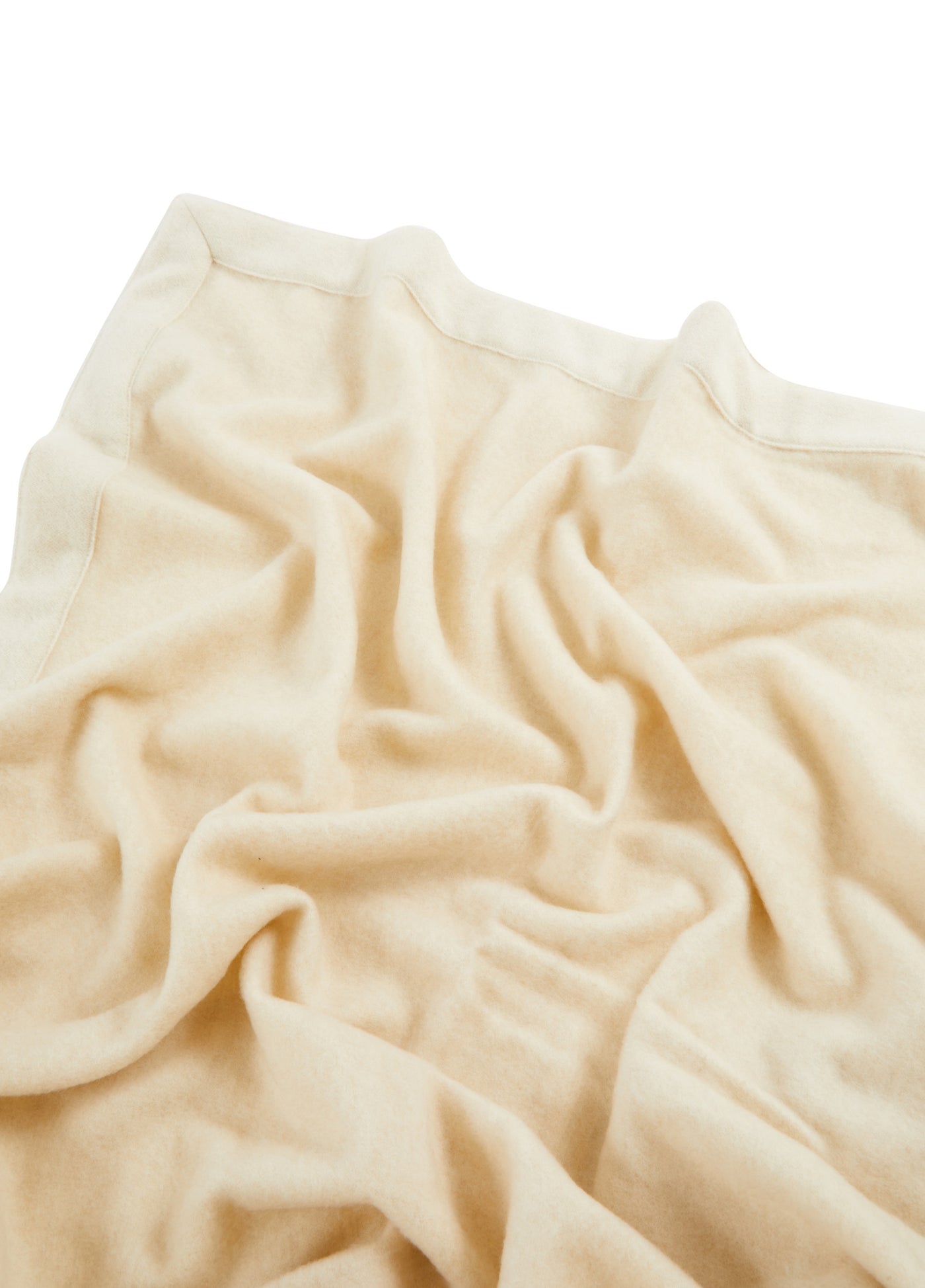Close-up of ivory Lanerossi Afrodite blanket showing soft drape and stitched hem detail.