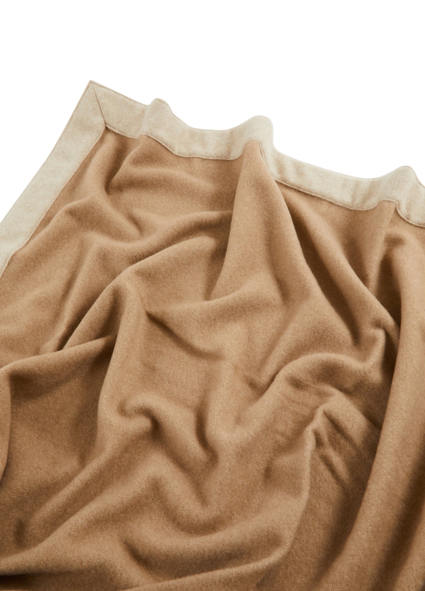 Camel-toned wool blanket draped loosely, showing ivory contrast border trim detail.