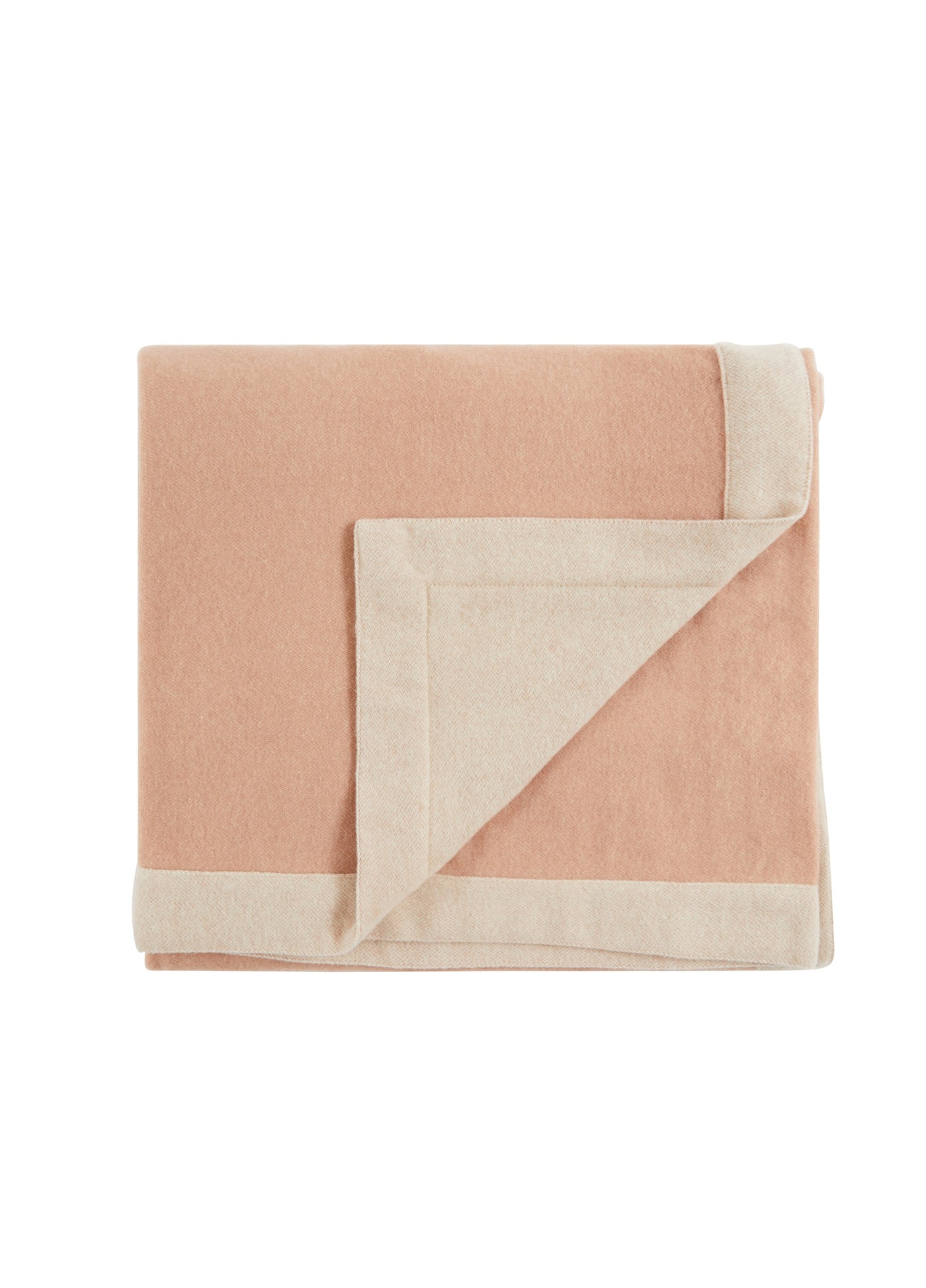 Folded blush blanket with contrast ivory border, corner turned to reveal reverse side.