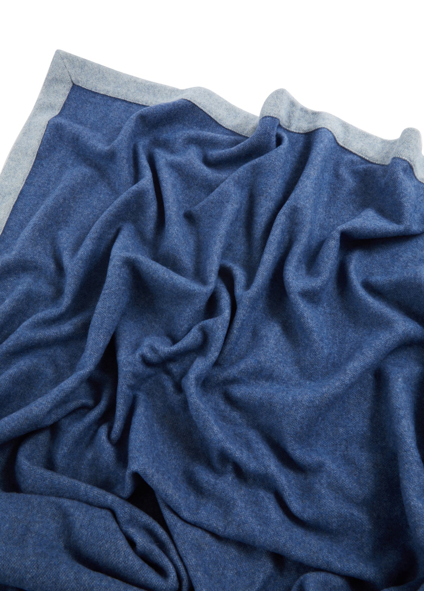 Reversible navy and silver-grey wool blanket, draped to show soft texture and contrast border.