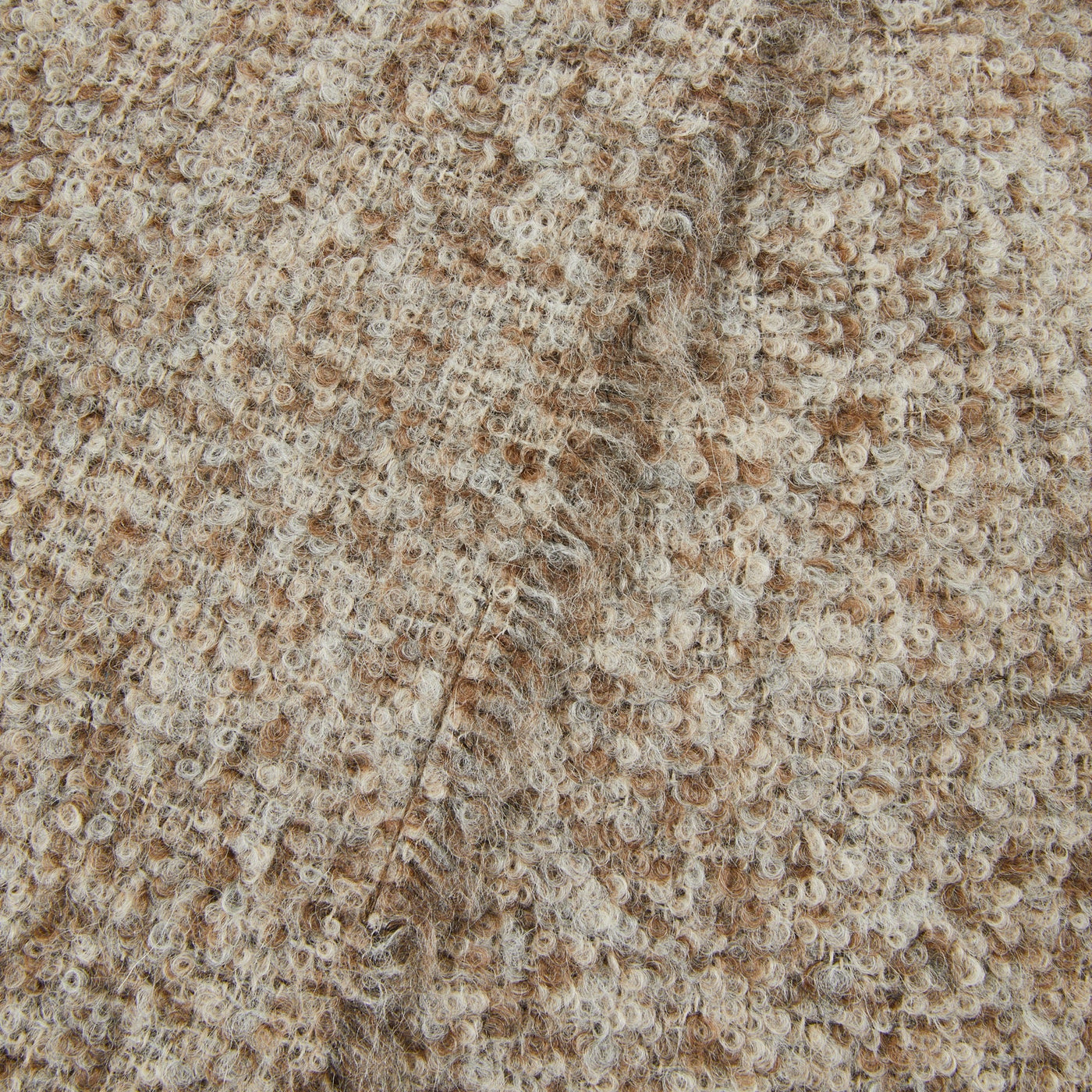 Close-up of Lanerossi Bogotà throw in camel and ivory boucle weave texture.