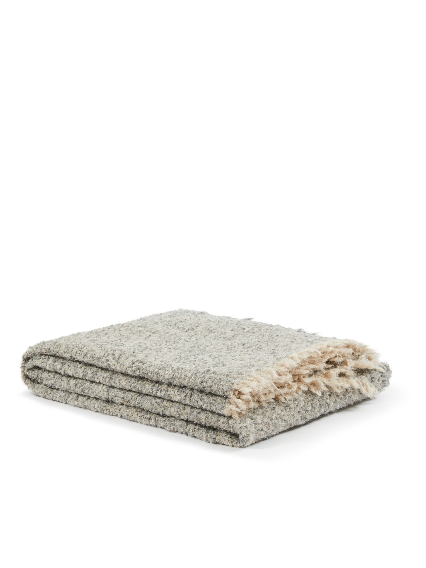Close-up of folded Bogotà throw in heathered grey boucle with cream fringe trim.