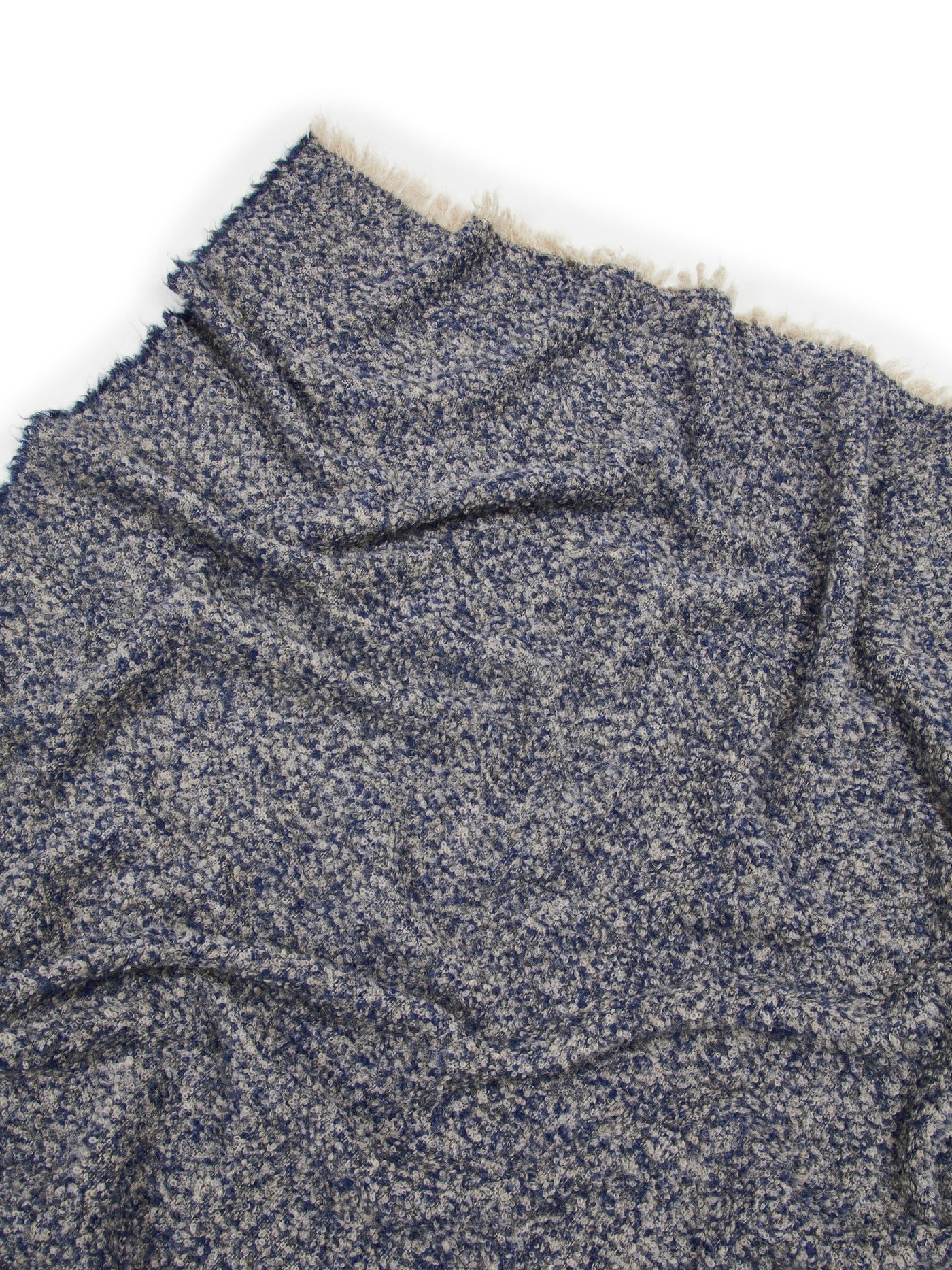 Close-up of Lanerossi Bogotà throw in navy boucle texture with ivory fringe edge.
