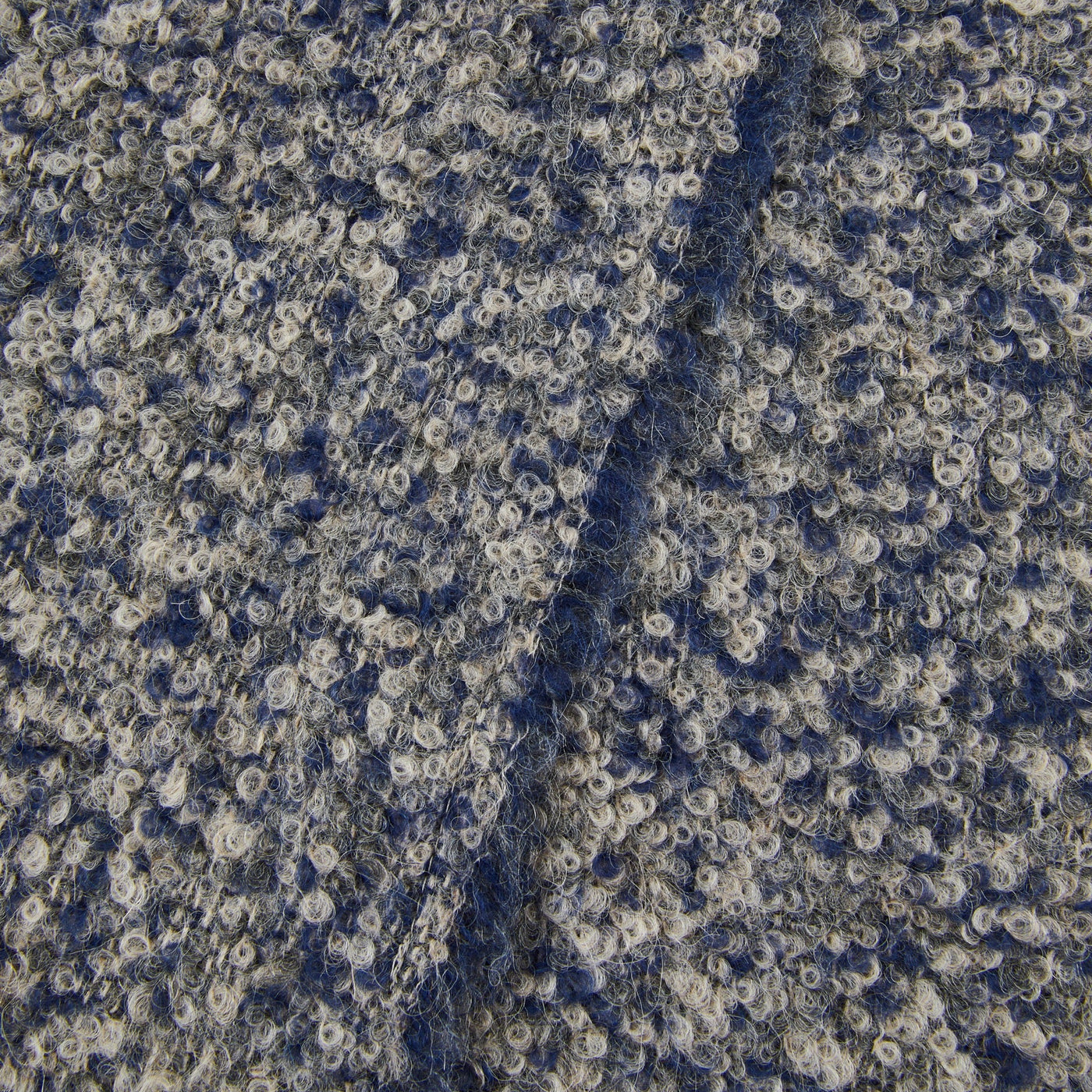 Close-up of Lanerossi Bogotà throw in navy, showing looped boucle weave texture with cream flecks.