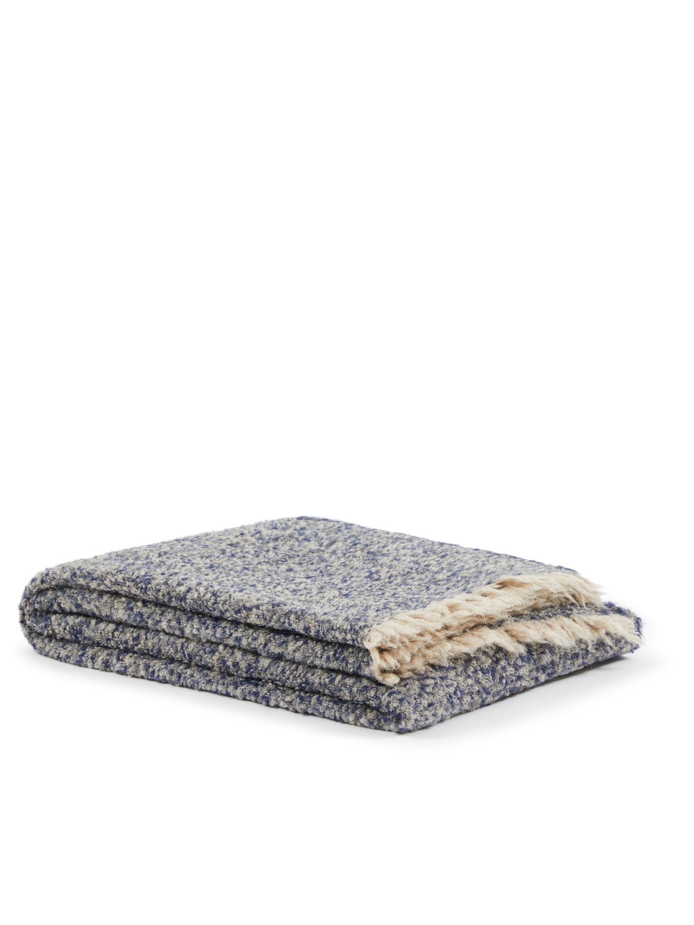Folded navy and ivory boucle throw with cream fringe trim, showing textured weave detail.