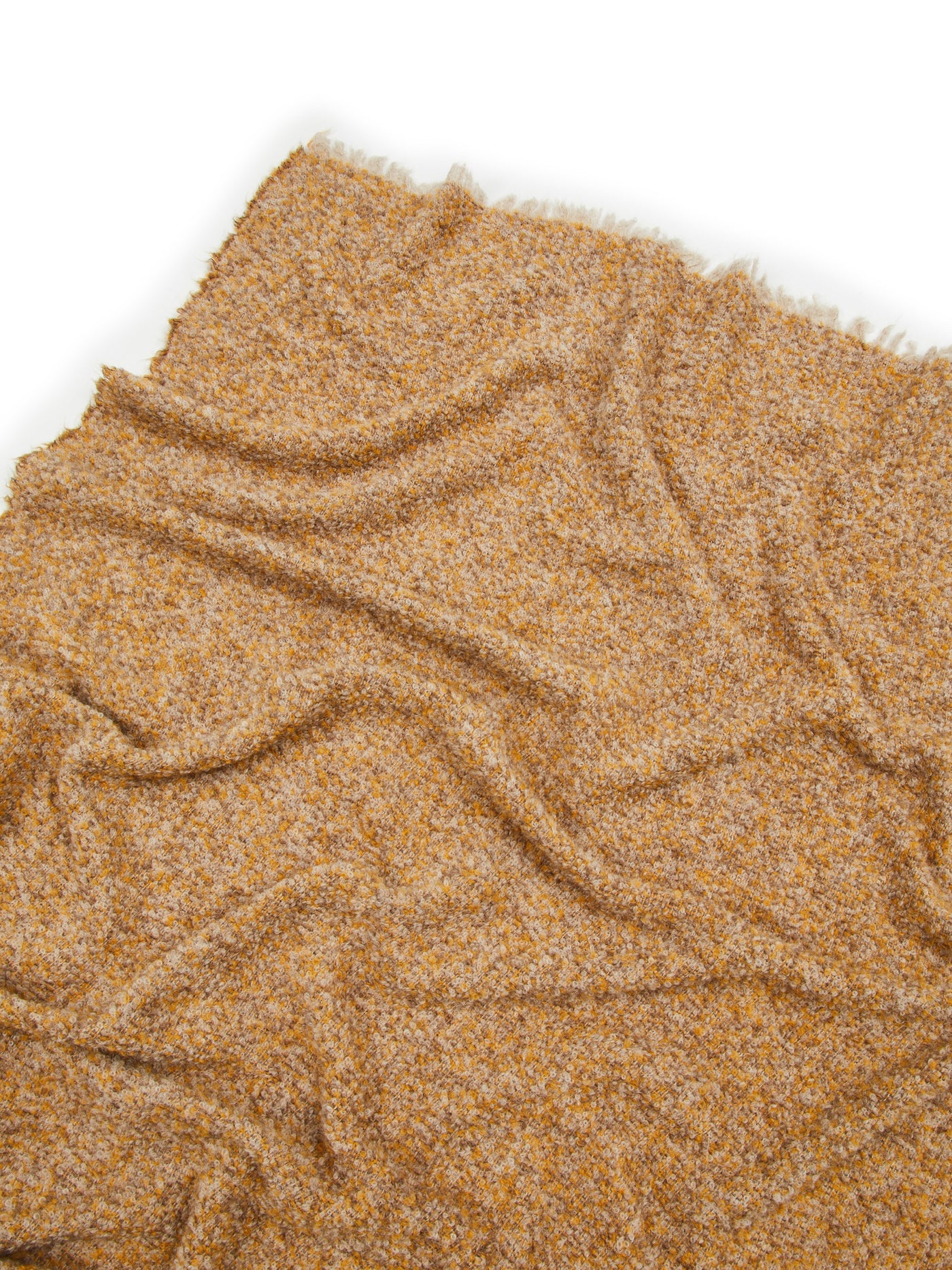 Close-up of Lanerossi Bogotà throw in amber, showing boucle texture and fringe trim.