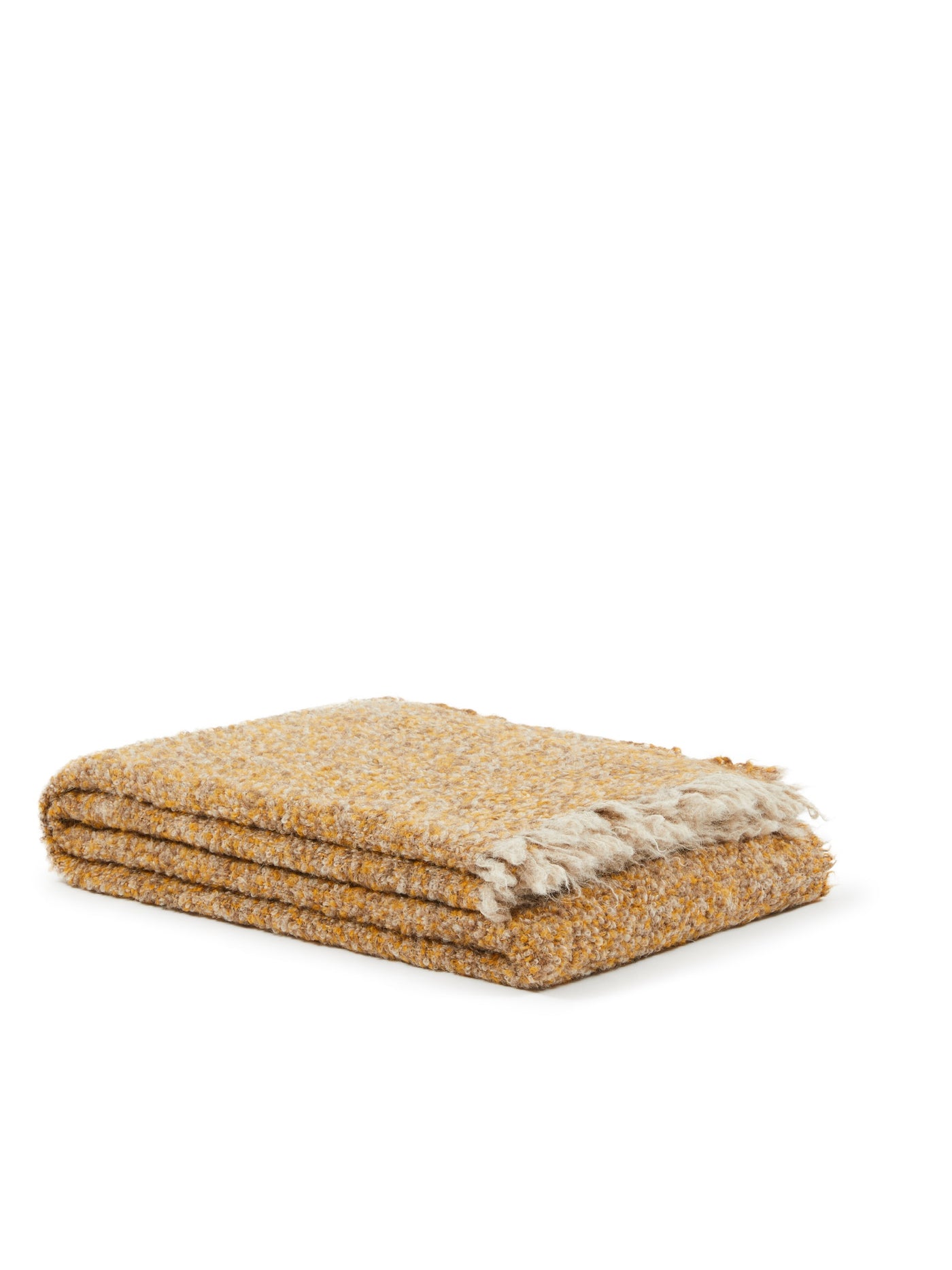 Folded saffron boucle throw with natural fringe trim, shown against white background.