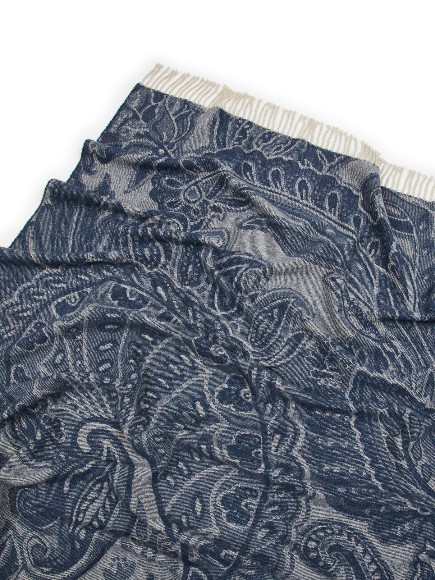 Close-up of Lanerossi Bohémien throw's navy paisley jacquard weave and fringe edge.