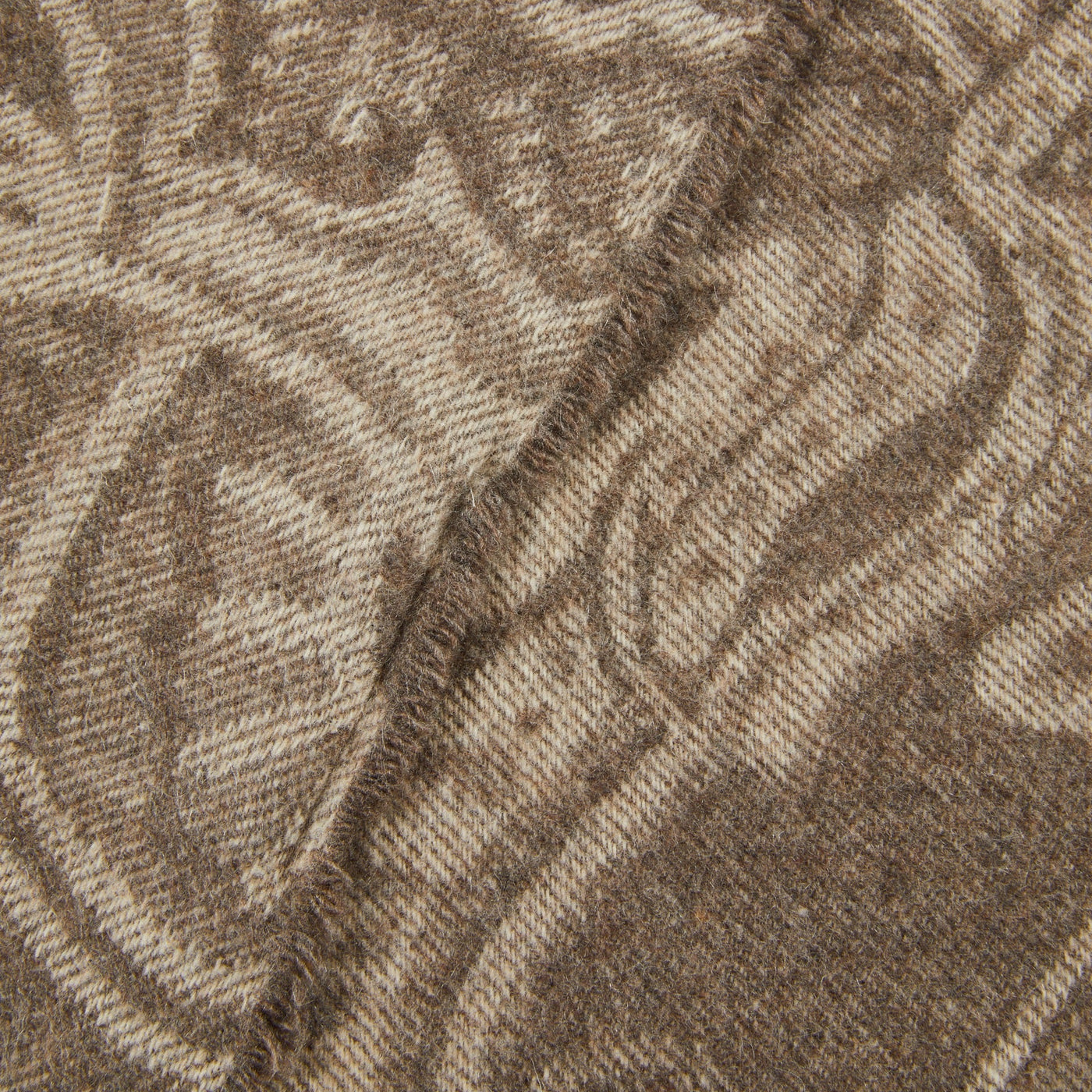Close-up of Lanerossi Bohémien throw's woven paisley pattern in toffee and sand tones with fringe edge.