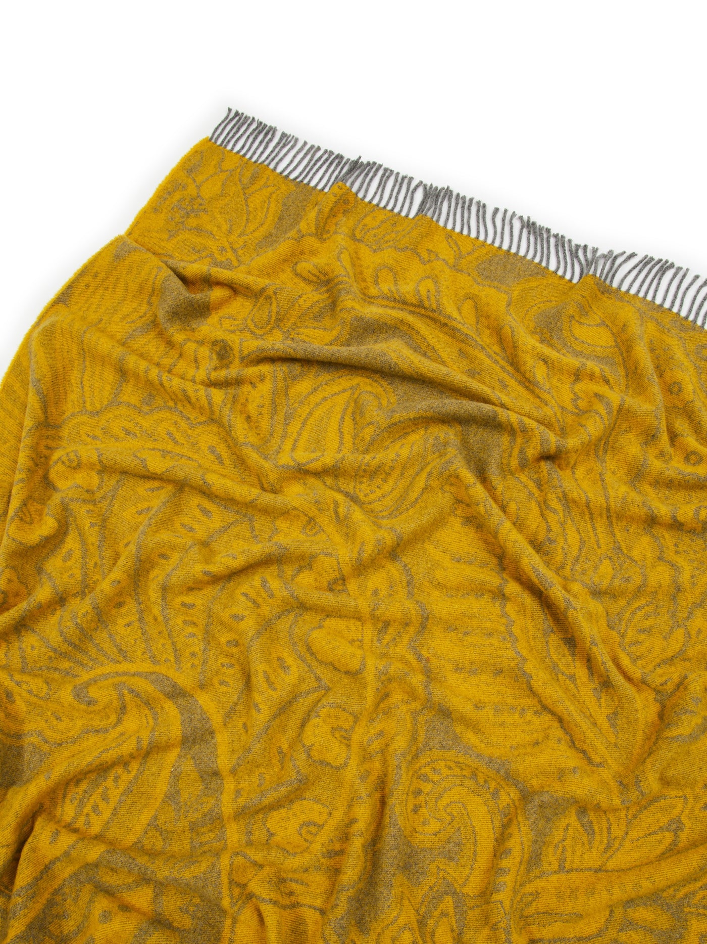 Close-up of saffron Lanerossi Bohémien throw, tonal paisley pattern with fringed edge.