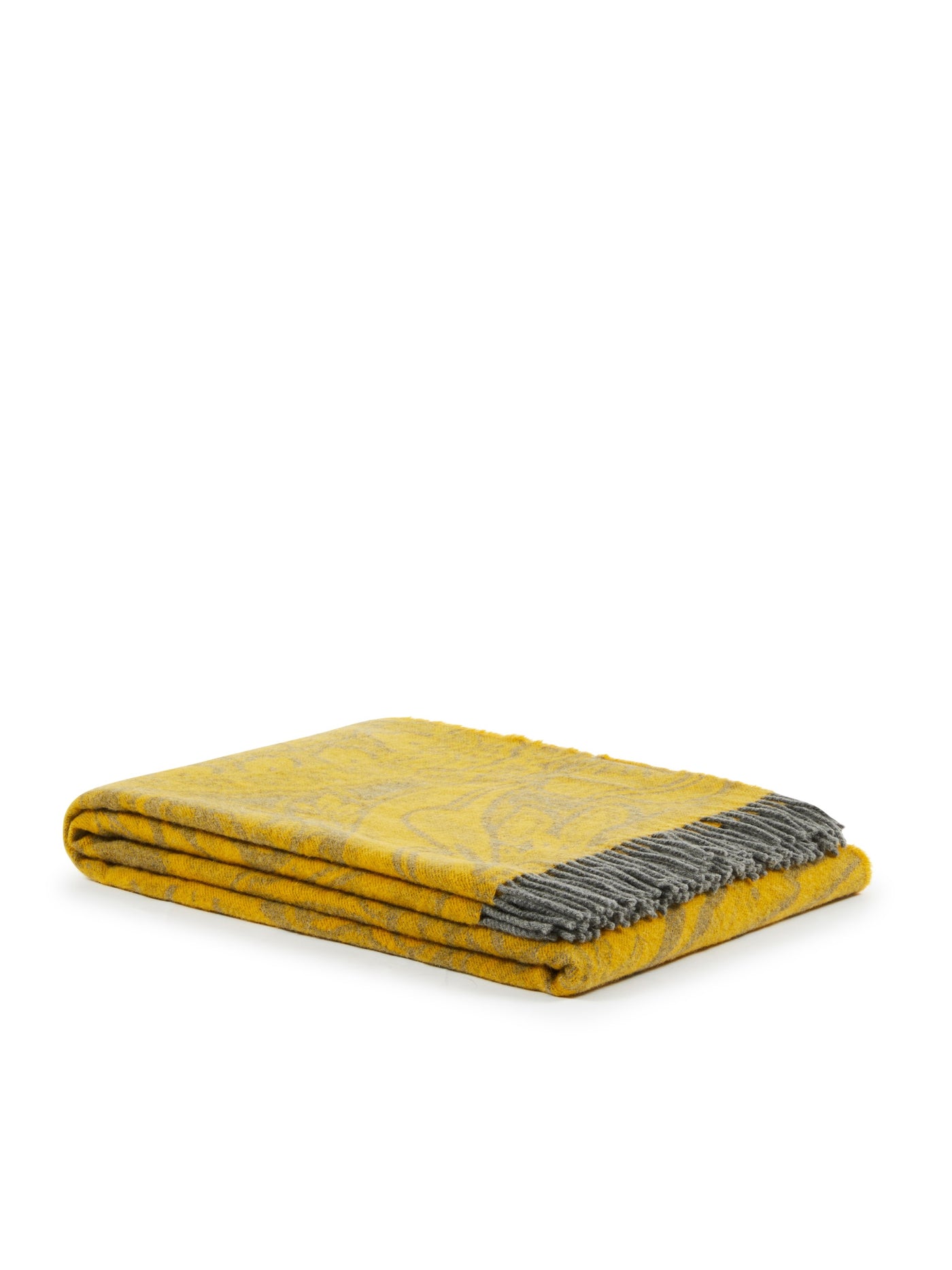 Folded saffron throw with grey jacquard pattern and fringed corner detail.