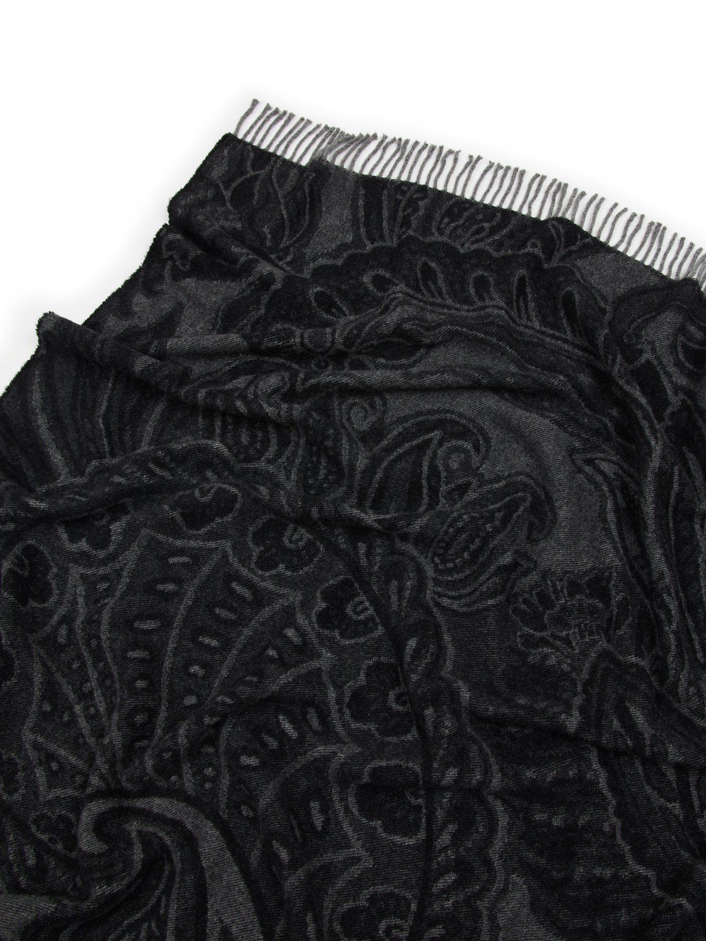 Close-up of Lanerossi Bohémien throw in black, showing tonal paisley jacquard and fringed hem.