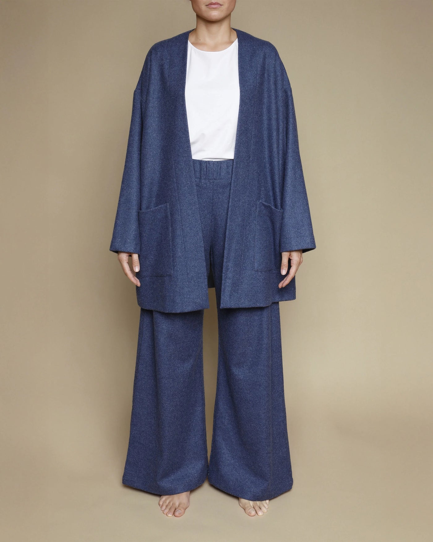 Lanerossi navy merino oversized cardigan styled open over wide-leg trousers, front view.