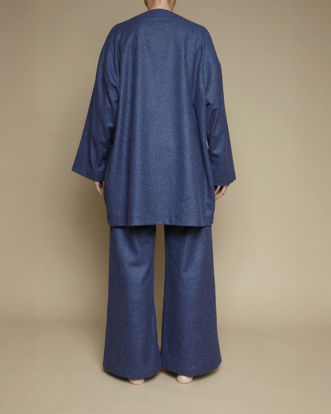 Back view of Lanerossi Extrafine Merino oversized cardigan in navy, styled with wide-leg trousers.