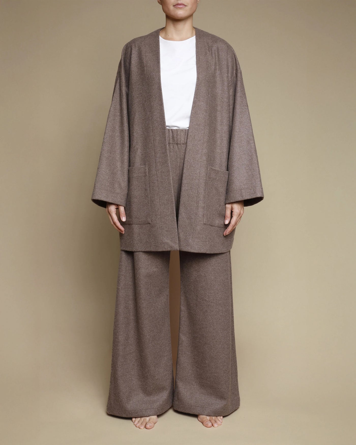 Model wearing Lanerossi taupe merino oversized cardigan styled with matching wide-leg trousers.