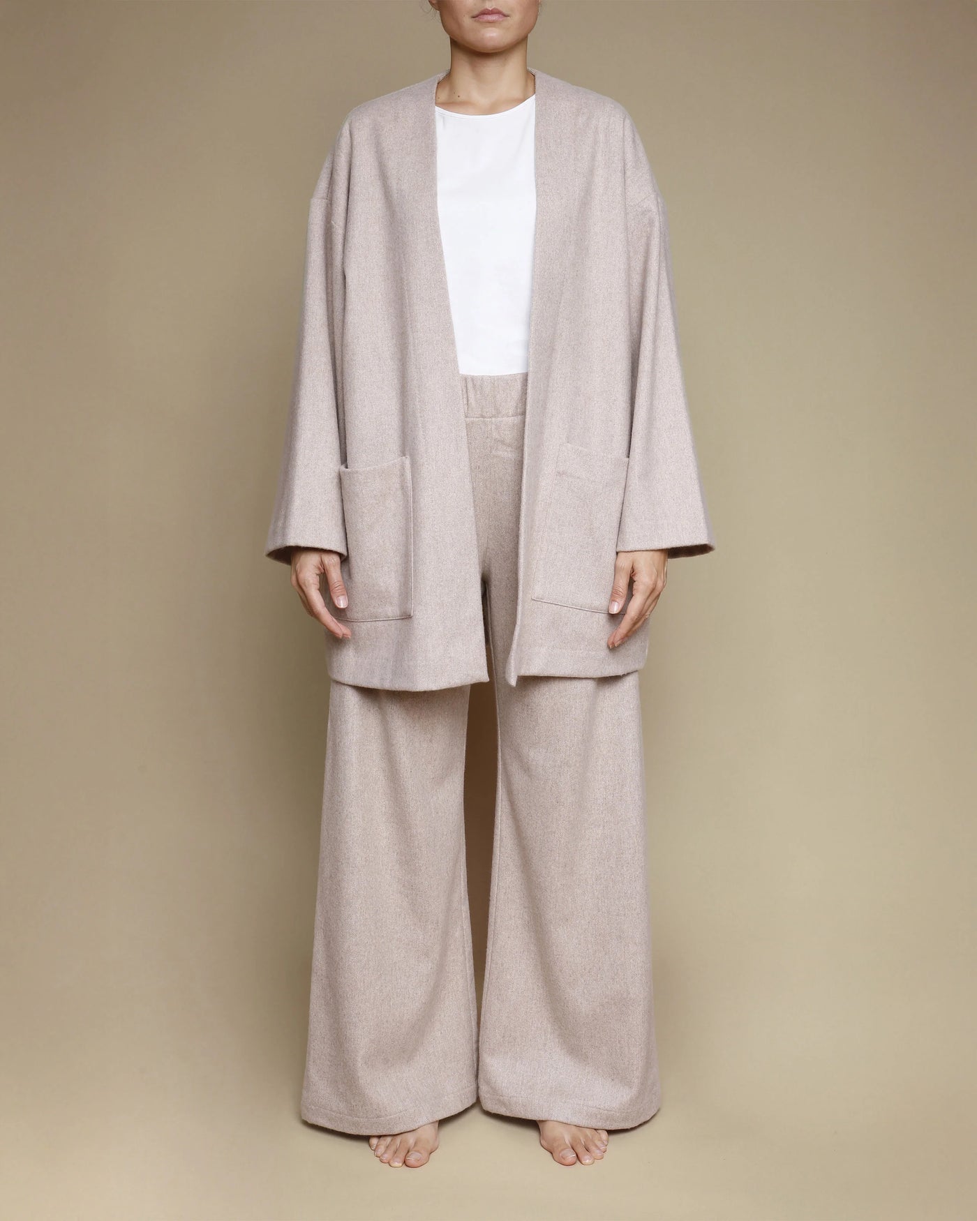 Close-up of Lanerossi Extrafine Merino oversized cardigan in oatmeal, styled with matching wide-leg trousers.