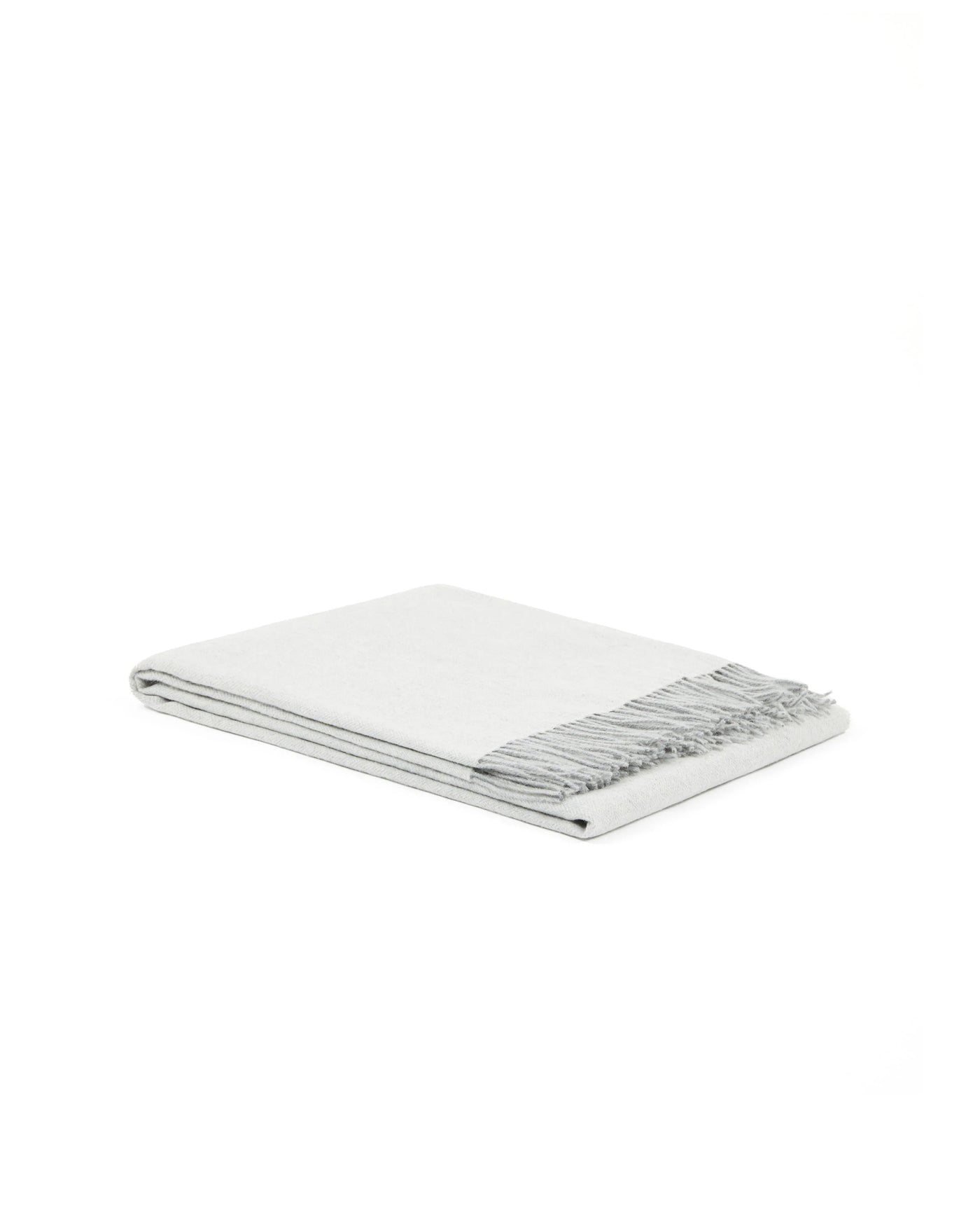 Folded ivory throw with contrast grey fringe trim detail.