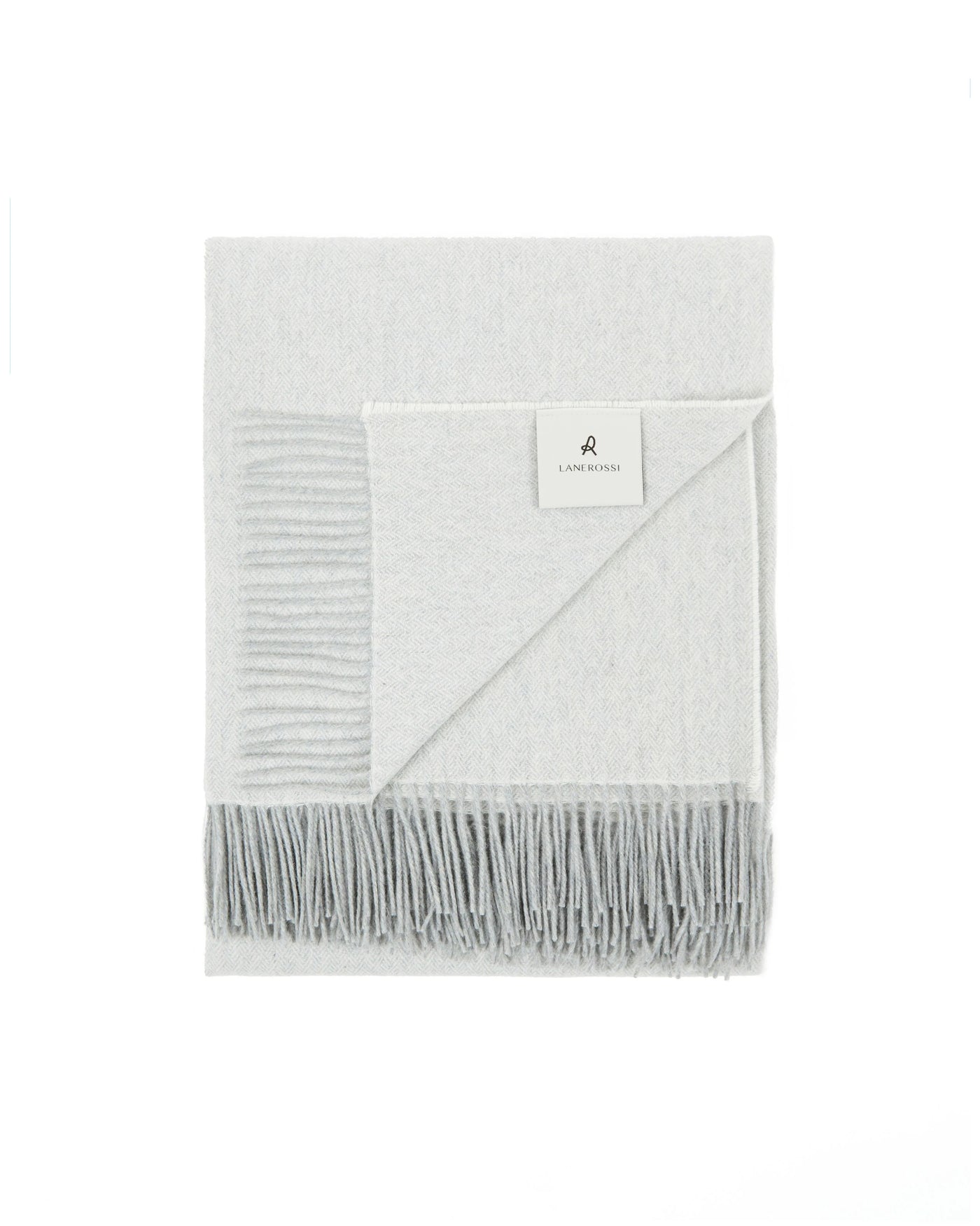 Folded ivory and grey Lanerossi Cassiopea throw with fringed hem and woven label.