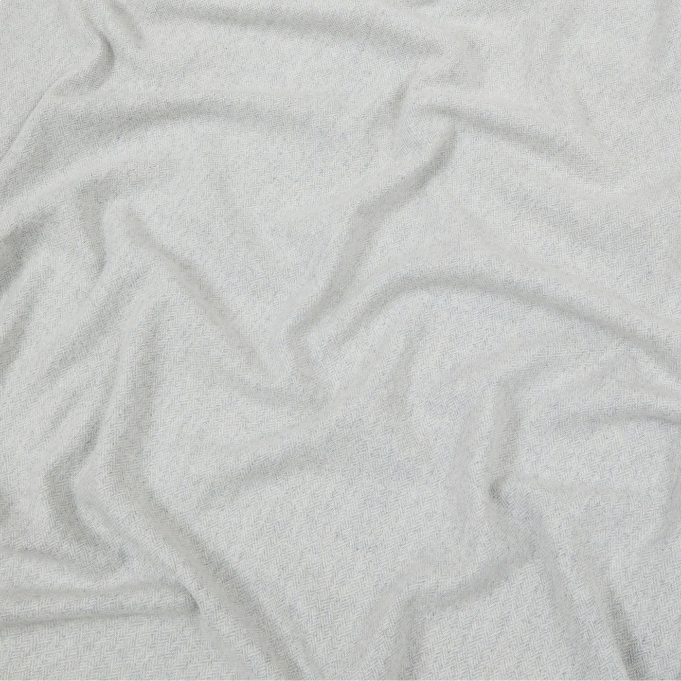 Close-up of draped silver-white Lanerossi Cassiopea throw showing soft brushed texture.