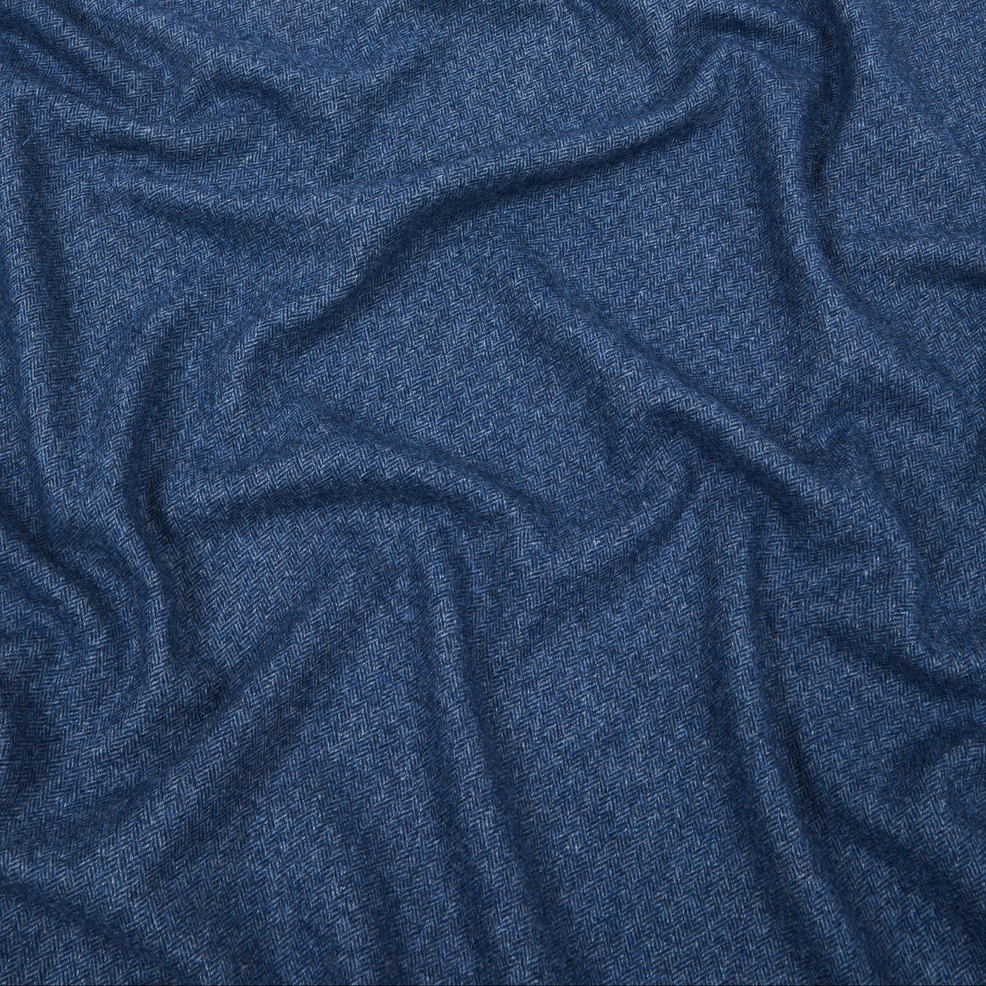 Close-up of Lanerossi Cassiopea throw in navy blue, showing soft draped wool fabric texture.