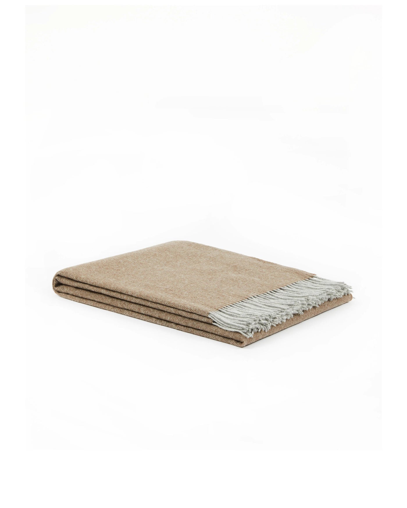 Folded camel and ivory reversible wool throw with knotted fringe trim detail.
