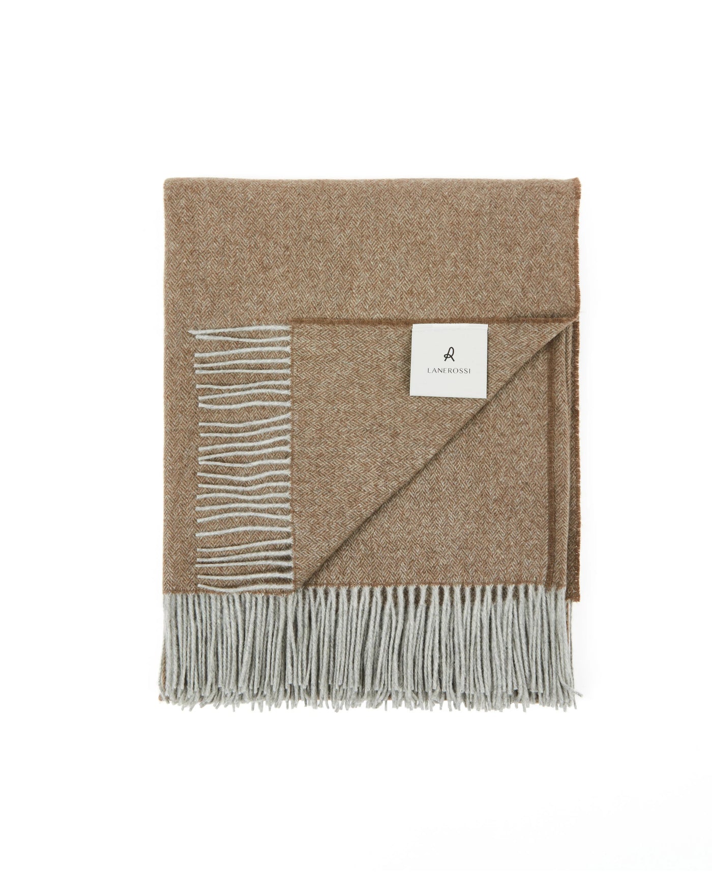 Folded camel wool throw with grey fringe, corner turned to reveal reversible silver-grey underside.
