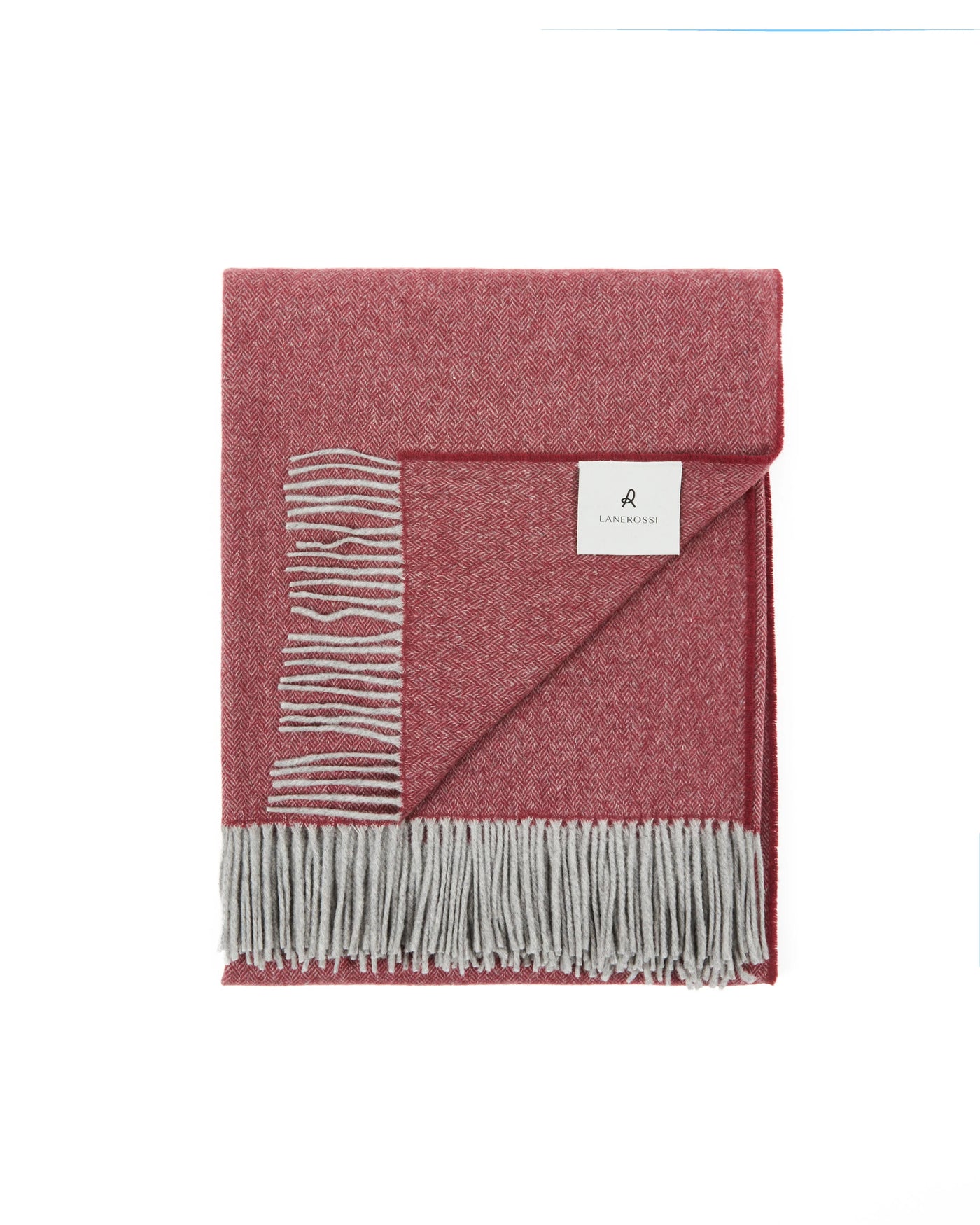 Lanerossi Cassiopea throw folded, raspberry and grey herringbone weave with fringed hem.