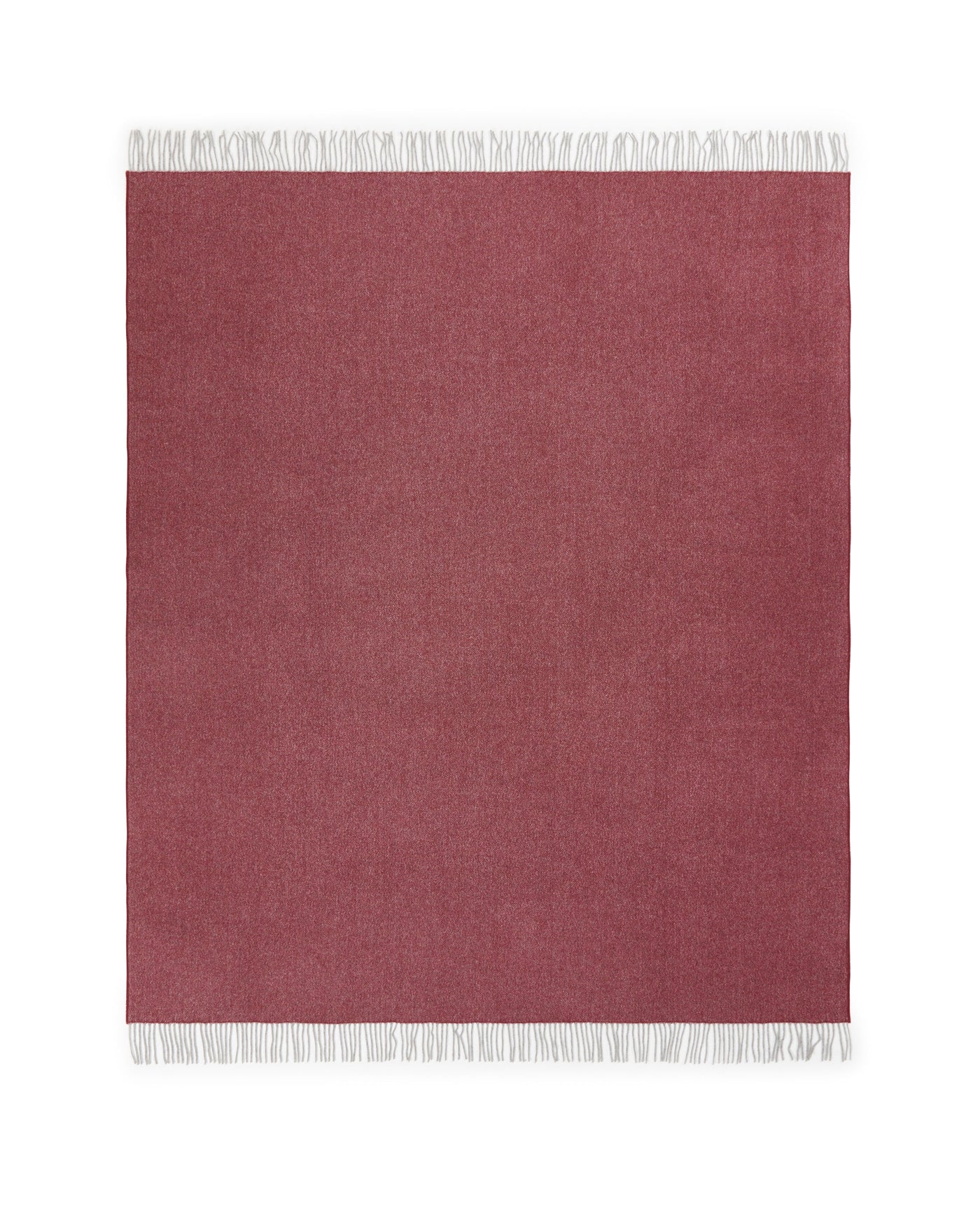 Raspberry herringbone wool throw with white fringe trim, flat lay view.