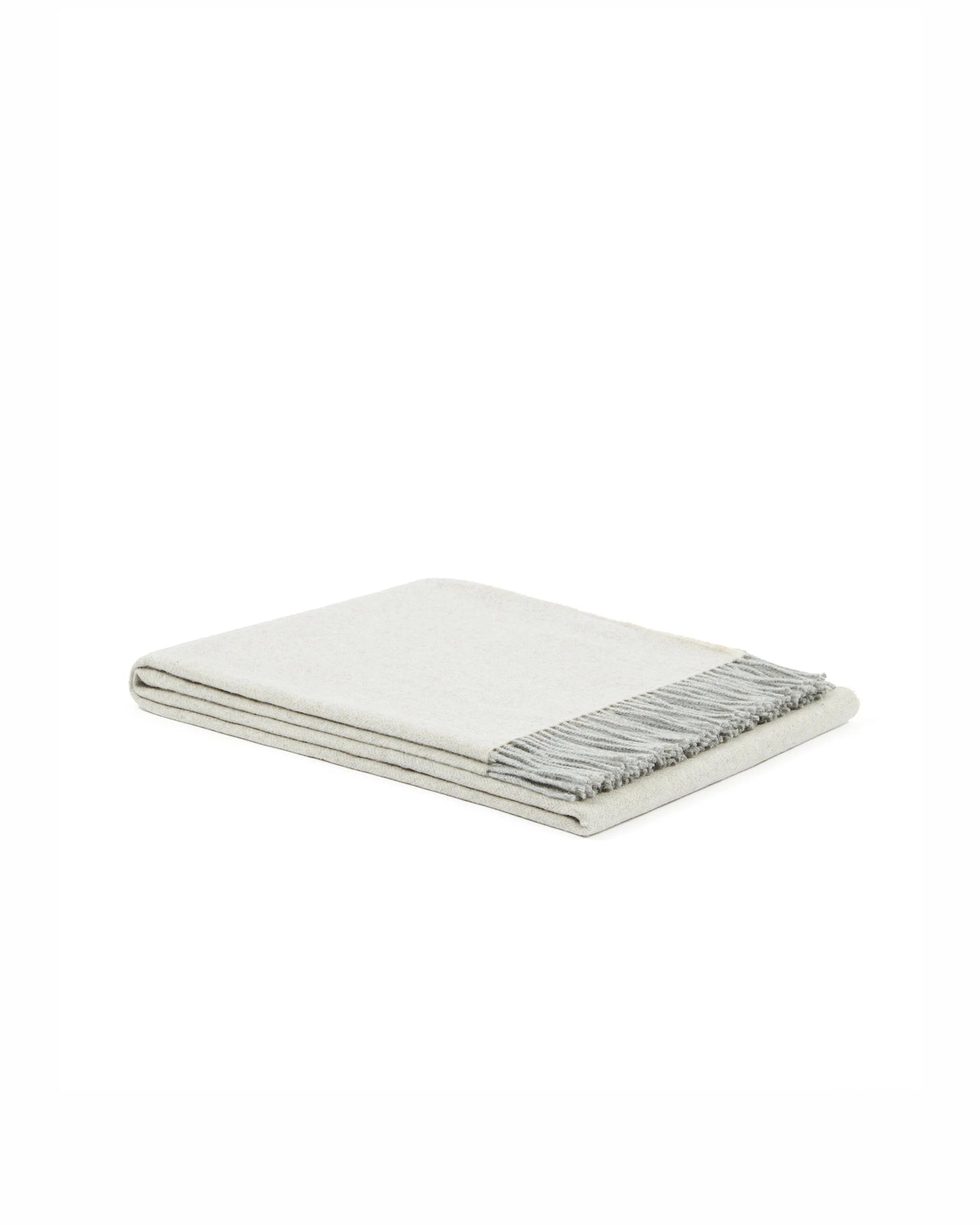 Folded ivory throw with twisted grey fringe trim, angled view showing layered edge detail.