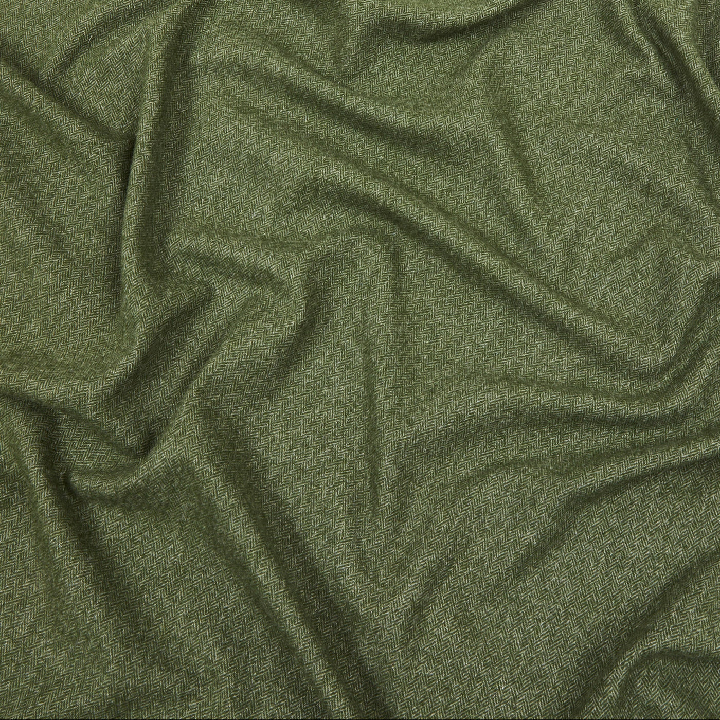 Close-up of draped olive green Lanerossi Cassiopea throw, showing heathered wool texture.