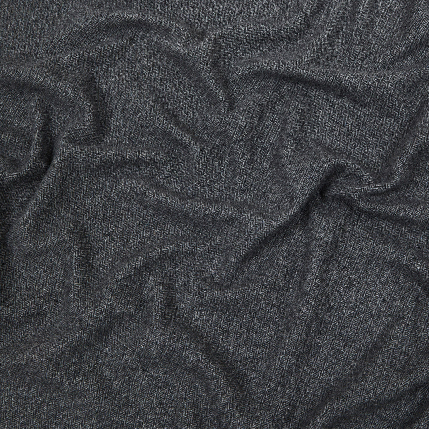 Close-up of draped charcoal Lanerossi Cassiopea throw showing soft wool texture and folds.