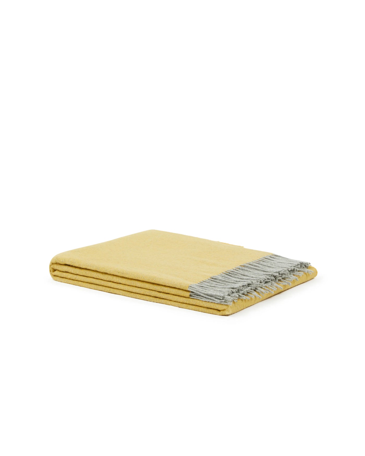 Cassiopea throw folded flat, golden yellow with contrast grey fringe trim.