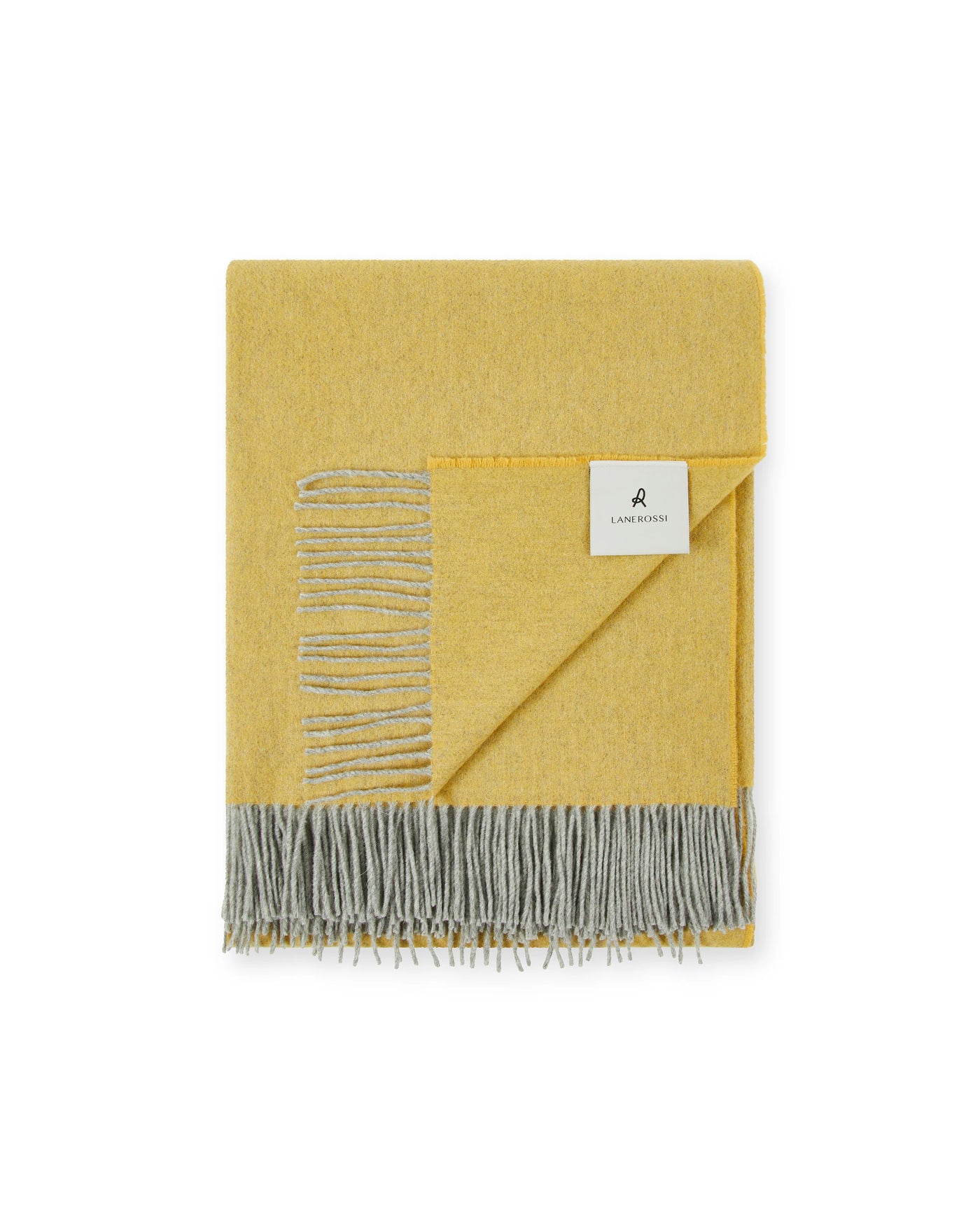 Folded mustard yellow throw with grey fringe and embroidered stripe detail, Lanerossi label visible.